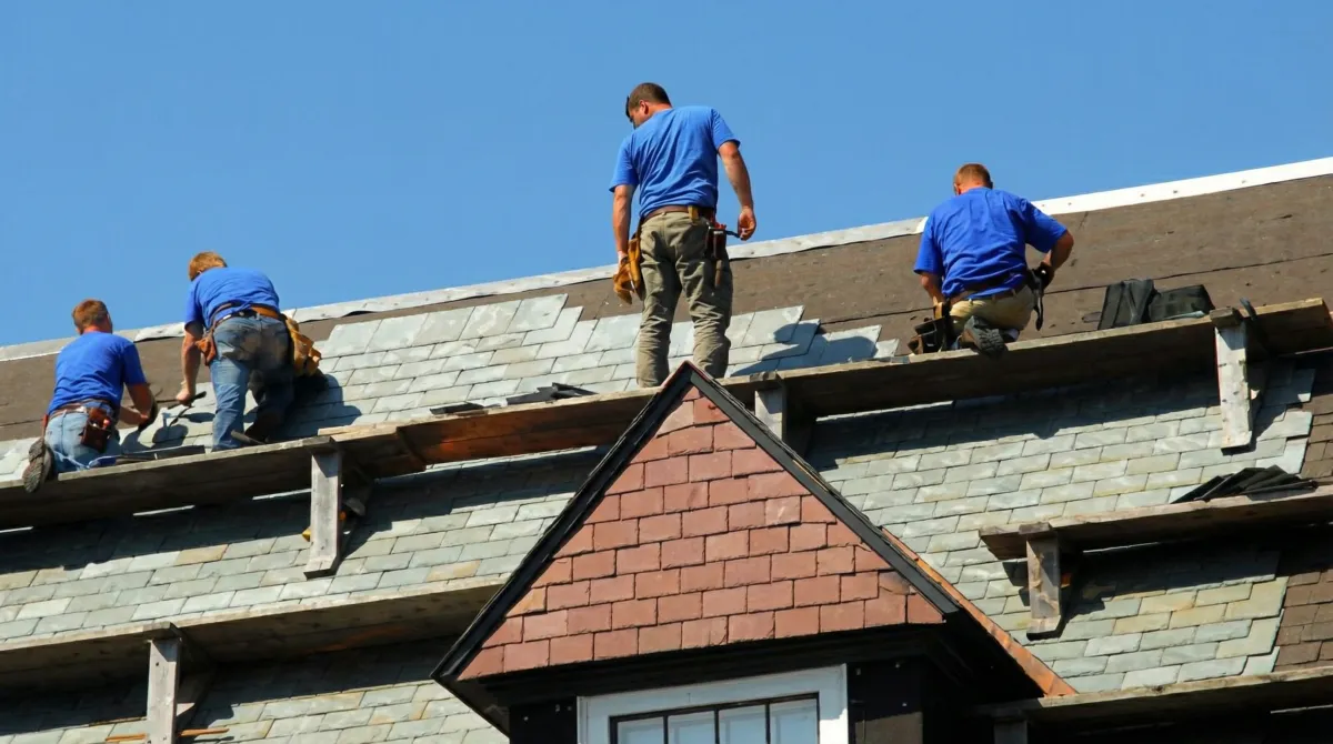 Roof replacement in progress with a team of professional contractors installing new shingles on a residential home in Savannah, GA