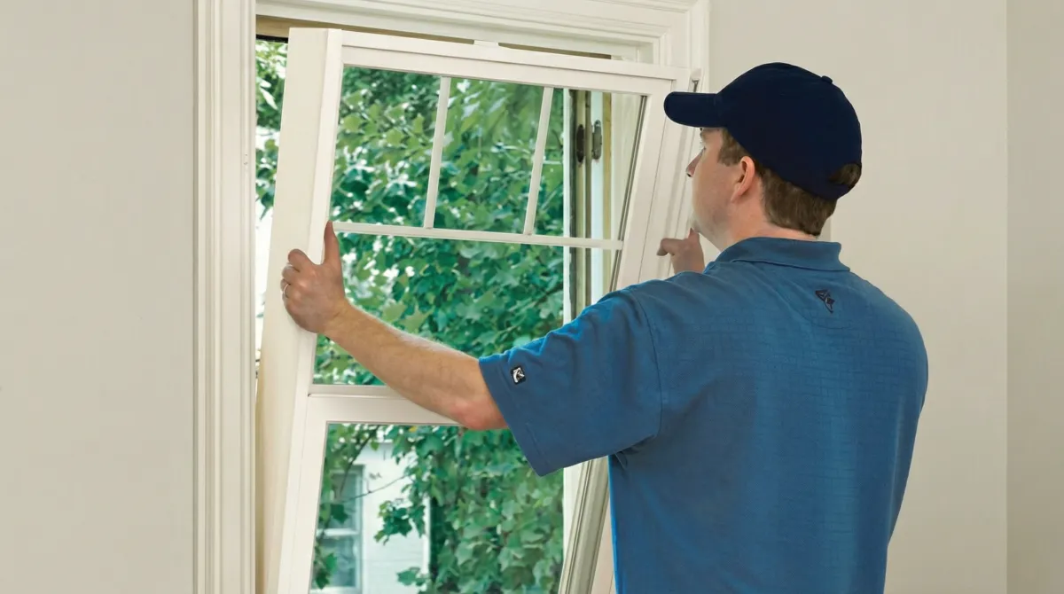 Professional contractors performing a residential window insulation and replacement service in Savannah, GA